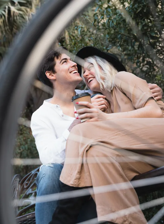 low-angle-happy-couple-bench