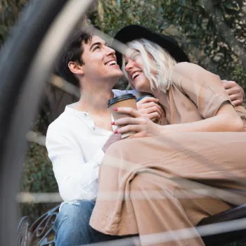 low-angle-happy-couple-bench